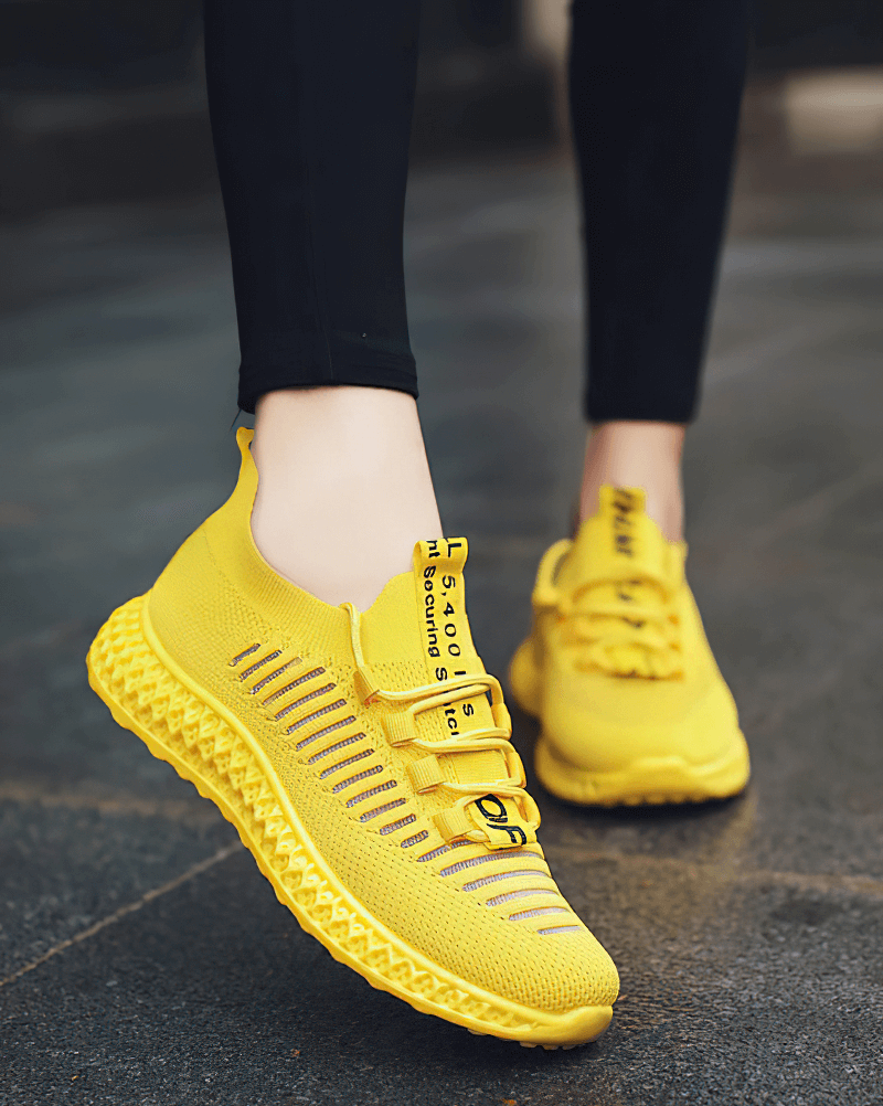 Bright yellow mesh breathable sneakers with lace-up design, perfect for women seeking casual comfort and style in flat bottom shoes.